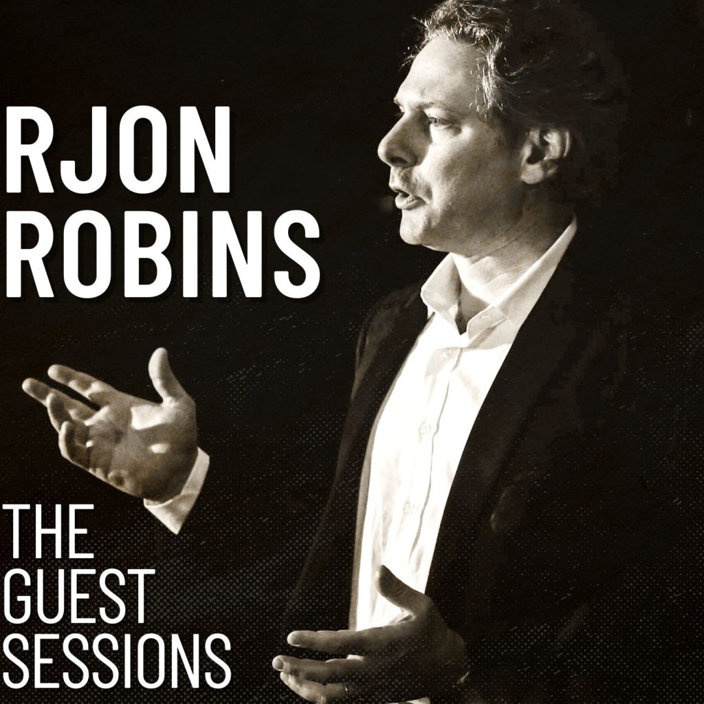 RJon Robins: The Guest Sessions podcast album art. Image: (right side) close up photo of RJon Robins speaking on stage. He is mid-sentence. His hands are animated as if he is expressing an idea to the audience. (left side) Text: RJON ROBINS THE GUEST SESSIONS. Image is black and white/noir